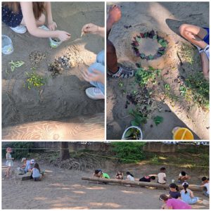 Kinder legen Bilder in den Sand.